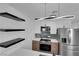 Bright kitchen features stainless steel appliances, quartz countertops, modern cabinets, and light wood flooring at 1108 Putnam Ave, North Las Vegas, NV 89030