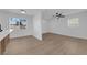Bright living room featuring new floors, a ceiling fan, and ample natural light through the windows at 1108 Putnam Ave, North Las Vegas, NV 89030