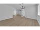 Bright living room featuring an open layout, modern chandelier, and seamless flow into the adjacent room at 1108 Putnam Ave, North Las Vegas, NV 89030