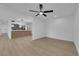 Bright living room featuring new floors, a ceiling fan, and ample natural light through the windows, with kitchen in the background at 1108 Putnam Ave, North Las Vegas, NV 89030