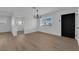 Bright living room featuring modern chandelier, and a front door at 1108 Putnam Ave, North Las Vegas, NV 89030