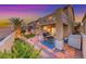 Beautiful backyard oasis with a covered patio, lush lawn, and well-maintained landscaping at 11334 Patores St, Las Vegas, NV 89141