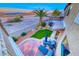 Stylish backyard with green grass, a brick patio, desert landscaping, and mountain views at 11334 Patores St, Las Vegas, NV 89141