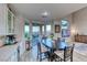 Bright dining room with sliding glass doors, modern table, and stylish decor at 11334 Patores St, Las Vegas, NV 89141
