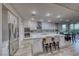 Open kitchen area features a large center island, stainless appliances, and tile flooring at 11334 Patores St, Las Vegas, NV 89141