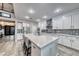 Spacious open kitchen with large island, white cabinets, stainless appliances, and barstool seating at 11334 Patores St, Las Vegas, NV 89141