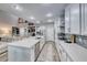 Open kitchen offers a large center island, stainless appliances, and stylish backsplash at 11334 Patores St, Las Vegas, NV 89141