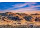 Stunning desert mountain range view with a new building and road construction at 11334 Patores St, Las Vegas, NV 89141