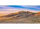 Beautiful sunset view of the mountains and rugged desert terrain at 11334 Patores St, Las Vegas, NV 89141