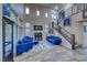 Spacious living room with high ceilings, modern furniture, and a staircase at 11334 Patores St, Las Vegas, NV 89141