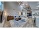 Spacious living room with high ceilings, a large sectional sofa, and a modern entertainment center at 11334 Patores St, Las Vegas, NV 89141
