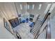 Open-concept living room featuring high ceilings, a staircase, and stylish decor at 11334 Patores St, Las Vegas, NV 89141