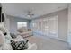 Bright living room boasts plush sofas, a ceiling fan, and built-in storage cabinets at 11334 Patores St, Las Vegas, NV 89141