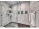 Stunning walk-in shower with glass surround, and white marble style tile at 11334 Patores St, Las Vegas, NV 89141