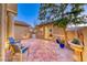 Charming patio with outdoor seating, tiled flooring, and a tranquil water feature at 11334 Patores St, Las Vegas, NV 89141