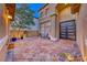 Inviting patio with tiled flooring, seating area, and a stylish entrance door at 11334 Patores St, Las Vegas, NV 89141