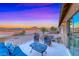 Comfortable patio seating offers a stunning view of the mountains during twilight at 11334 Patores St, Las Vegas, NV 89141