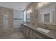 This spacious bathroom features a double vanity and a walk-in shower with decorative tile at 12 Golden View St, Henderson, NV 89012