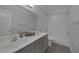 Bathroom featuring double sinks, granite countertops, a large mirror, and a shower-tub combo at 12 Golden View St, Henderson, NV 89012
