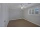 A carpeted bedroom featuring neutral colored walls, white trim and plantation shutters at 12 Golden View St, Henderson, NV 89012