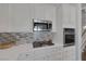 Kitchen showcasing stainless steel appliances, white cabinets, and a decorative backsplash at 12 Golden View St, Henderson, NV 89012
