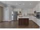 Well-lit kitchen with stainless appliances, center island, and sleek white cabinets at 12 Golden View St, Henderson, NV 89012