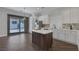 Modern kitchen with stainless appliances, center island, and sliding doors to backyard at 12 Golden View St, Henderson, NV 89012
