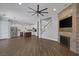 Open-concept living space with hardwood floors and a stone fireplace accent wall at 12 Golden View St, Henderson, NV 89012