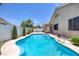 Backyard pool with lush landscaping, a well-maintained patio, and a privacy fence at 12 Golden View St, Henderson, NV 89012