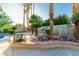 Backyard with outdoor kitchen, fire pit, and sparkling swimming pool at 1393 Calmview Pl, Las Vegas, NV 89110
