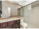 Bathroom featuring a vanity with drawers, toilet, and shower with glass door, providing functionality at 1393 Calmview Pl, Las Vegas, NV 89110