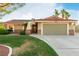 Inviting single-story home featuring a well-manicured lawn, desert landscaping, and an attached two-car garage at 1393 Calmview Pl, Las Vegas, NV 89110