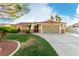 Inviting single-story home featuring a well-manicured lawn, desert landscaping, and an attached two-car garage at 1393 Calmview Pl, Las Vegas, NV 89110