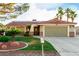 Inviting single-story home with a manicured lawn, desert landscaping, and a two-car garage at 1393 Calmview Pl, Las Vegas, NV 89110
