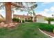 Charming single-story home with desert landscaping, green lawn, and a two-car garage at 1393 Calmview Pl, Las Vegas, NV 89110