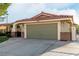 Spacious two-car garage with concrete driveway and well-maintained desert landscaping at 1393 Calmview Pl, Las Vegas, NV 89110