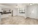 Bright and airy living area with tile flooring, neutral walls, and an open layout connecting to the kitchen at 1393 Calmview Pl, Las Vegas, NV 89110