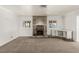 Spacious living room featuring a tile fireplace, built-in shelving, and carpet flooring at 1393 Calmview Pl, Las Vegas, NV 89110