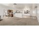 Spacious living area with carpet flooring, open layout, and views into the dining and kitchen areas at 1393 Calmview Pl, Las Vegas, NV 89110