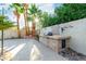Backyard featuring an outdoor kitchen with built in stone grill and stone countertop at 1393 Calmview Pl, Las Vegas, NV 89110