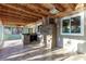 Covered patio with tile floors, a stone bar, and a built-in grill for outdoor entertaining at 1393 Calmview Pl, Las Vegas, NV 89110