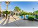 Backyard oasis with pool, outdoor kitchen, cabana, and lots of palm trees at 1393 Calmview Pl, Las Vegas, NV 89110