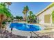 Backyard pool and jacuzzi with mature landscaping and palm trees at 1393 Calmview Pl, Las Vegas, NV 89110