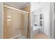 Modern bathroom with a glass-enclosed shower, soaking tub, and built-in shelving at 179 Adomeit Dr, Henderson, NV 89074