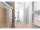 Bright bathroom with glass shower, bathtub and storage shelves at 179 Adomeit Dr, Henderson, NV 89074