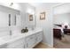 Bathroom featuring double sinks, white cabinets, and bright lighting at 179 Adomeit Dr, Henderson, NV 89074