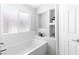 Bright bathroom with a built-in bathtub and decorative shelving at 179 Adomeit Dr, Henderson, NV 89074