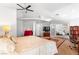 Bright bedroom featuring a ceiling fan, skylights, and an adjacent sitting area at 179 Adomeit Dr, Henderson, NV 89074