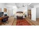 Spacious bedroom with a walk-out balcony door, ceiling fan, and private bathroom at 179 Adomeit Dr, Henderson, NV 89074