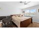Bedroom includes a ceiling fan, a window with neighborhood views, and a workspace with a desk at 179 Adomeit Dr, Henderson, NV 89074